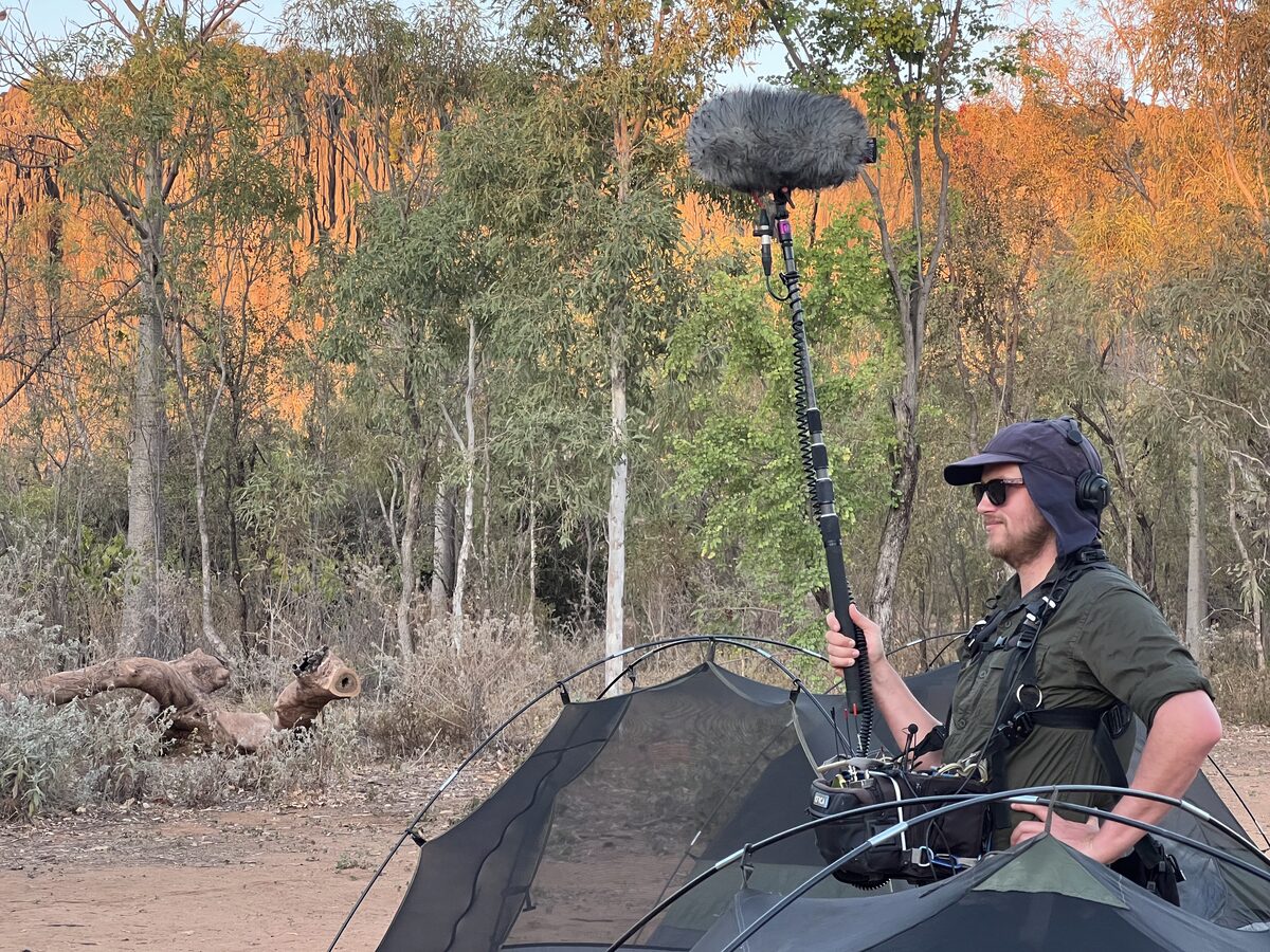 Richard Hubbard operating a boom microphone on location in the Australian outback